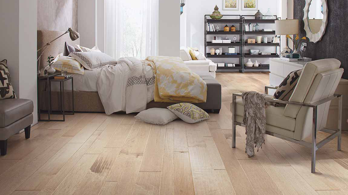 A cozy bedroom with hardwood floors