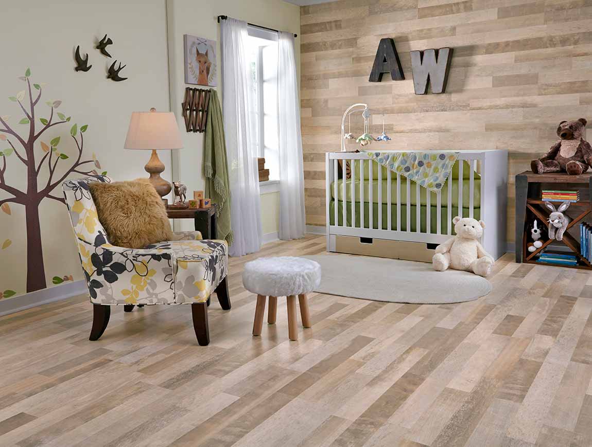 laminate flooring by Mannington, interior of a nursery with lighter wood-look laminate on floors and walls. 